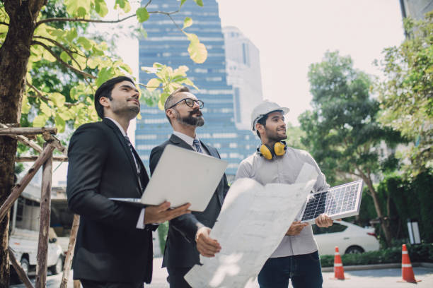 istock engineers or business partners cooperating on floor plans on a construction site. Architecture and teamwork concept. team discussion with construction on site work. 1320118298