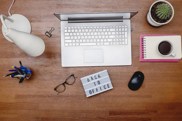 istock Top view of wooden table with laptop 1320118752