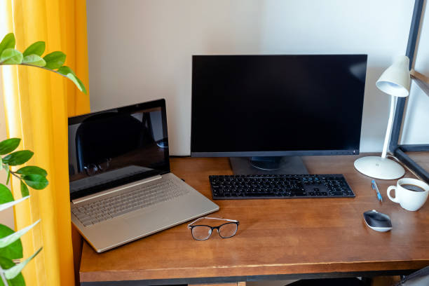 istock Workplace with wooden table and green plant. 1320118754