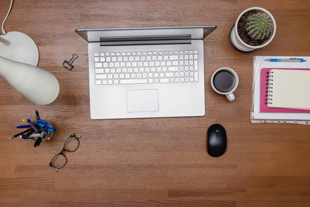 istock Top view of wooden table with laptop 1320118757