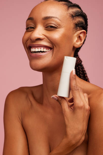 istock Smiling woman presenting beauty product 1320118849
