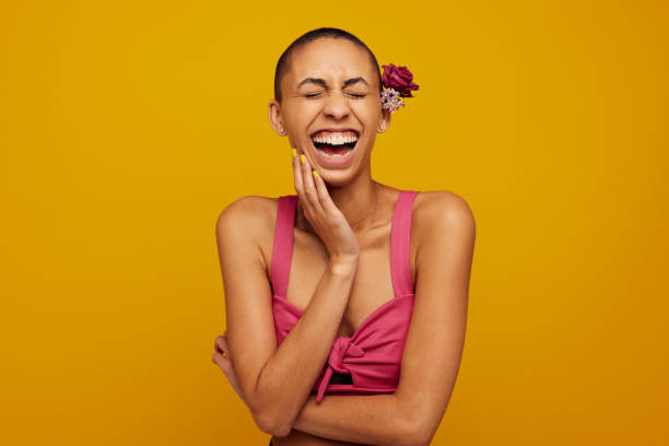istock Laughing female model with flowers on head 1320118983