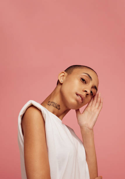 istock Woman with shaved head posing in studio 1320119709