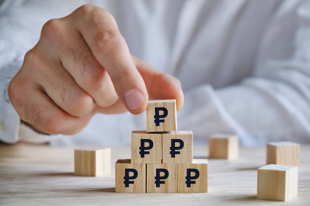 istock Men placing wooden blocks with Russian ruble signs, growth concept 1320121232