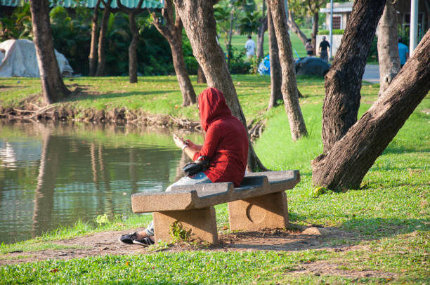 istock Woman sits on the bench in the park 1320122334