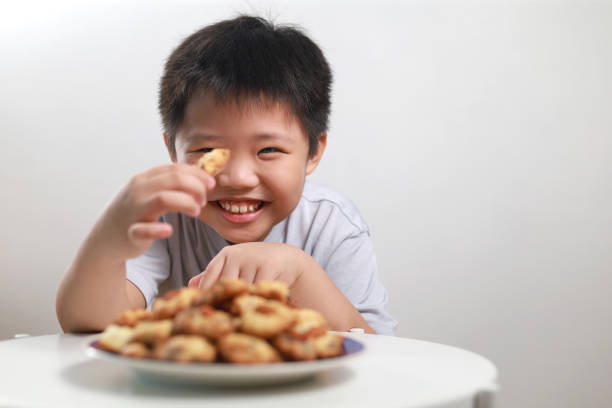 Young boy and a plate of cookies stock photo
