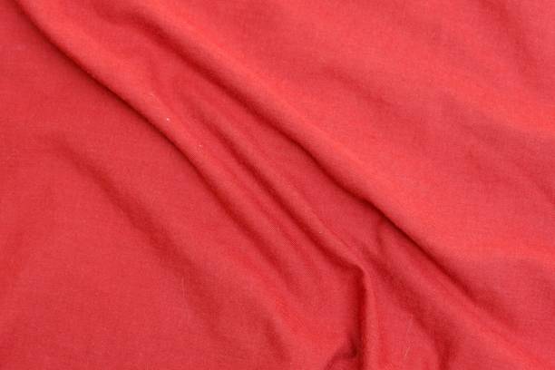 istock Smooth red silky soft sarong texture with beautiful closeup and elegant fabric detail background. 1320123012