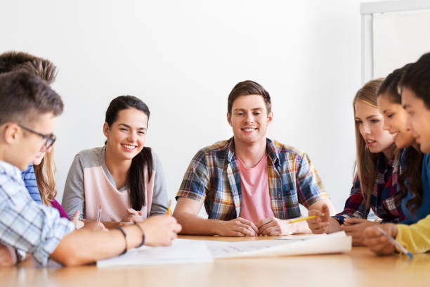 istock group of smiling students with blueprint 1320123896