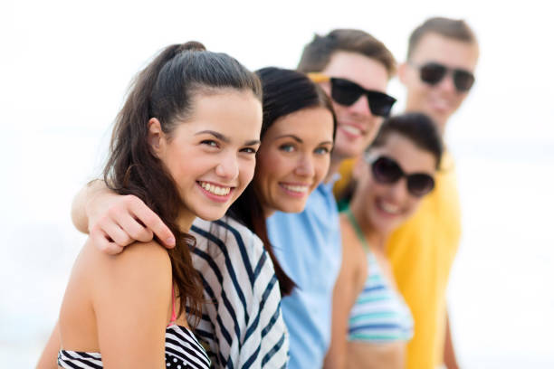 istock group of happy friends on beach 1320124043