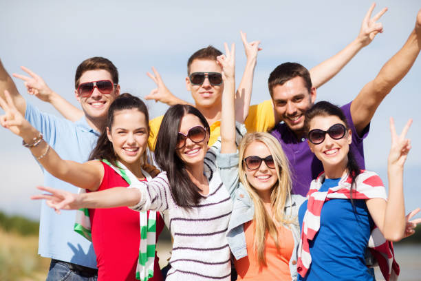 istock group of happy friends having fun on beach 1320124077