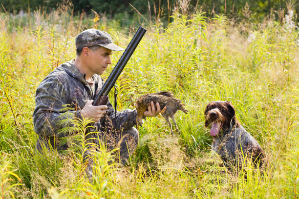 istock the hunter holds in his hand a downed grouse which was brought by his dog 1320124365