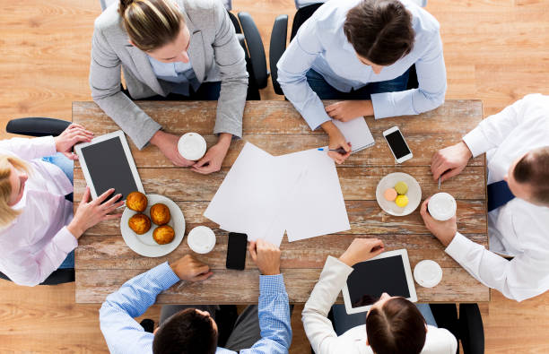 istock close up of business team drinking coffee on lunch 1320124634
