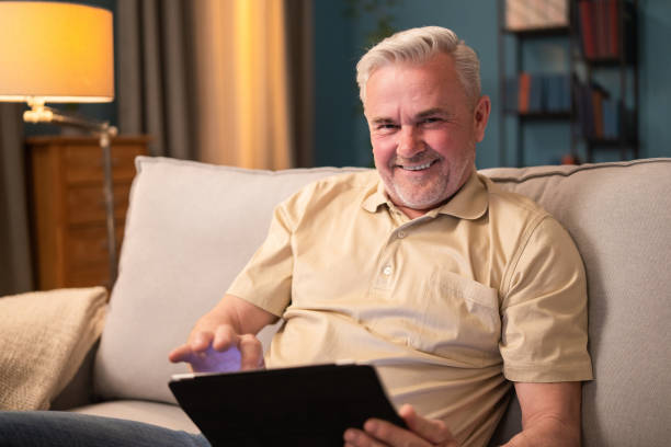 istock Retired man getting to know, learning to use tablet. Happy elderly man learning how the internet works. Proud older man sitting with a tablet. Relaxed senior man reading articles on the internet 1320125568