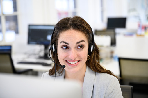 Communication expert talking on telephone with client or customer