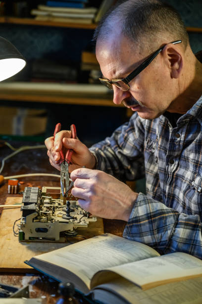 istock Man tries to fix a radio receiver 1320127135
