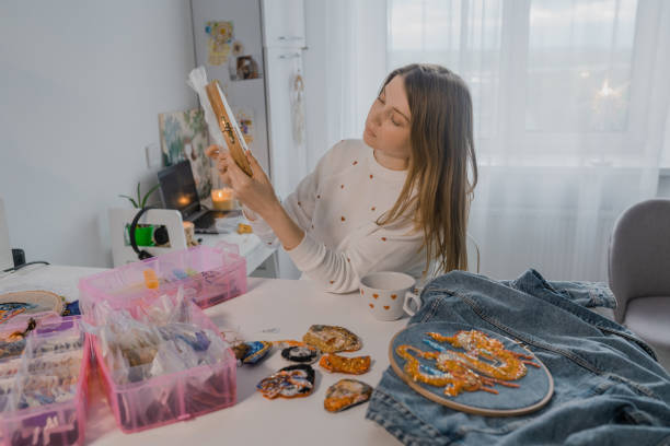 istock Woman embroidering  at home, sitting at kitchen 1320127163