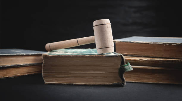 istock Judge gavel and book on the black background. 1320128225