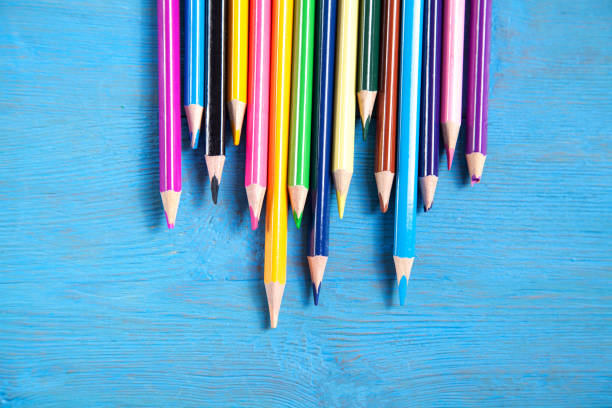 istock Colored pencils on the blue background. 1320128227