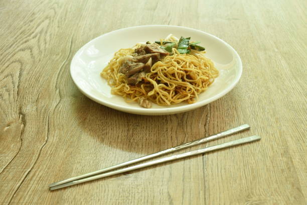 istock Chinese yellow egg noodles topping braised pork 1320128474