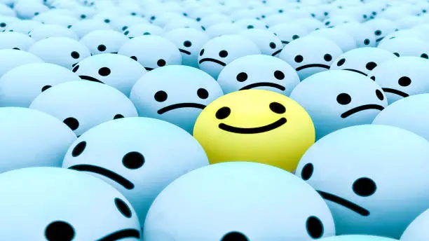 This image has small smile face ball which are of yellow and blue colour.