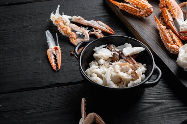 istock Cooked crab claws and legs meat, on black wooden table background 1320129372