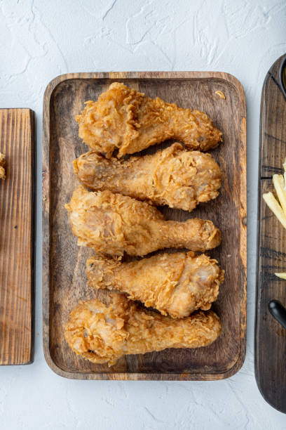 istock Crispy fried chicken leg on white background, flat lay 1320130072