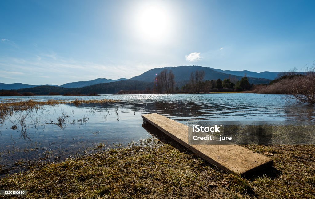 View of amazing lake Cerknica in Slovenia - Cerkniško jezero. View of amazing lake Cerknica in Slovenia - Cerkniško jezero. Beautiful intermittent or  disappearing  lakewith small boat pier in Slovenia karst, natural european landmark in Cerknica, Slovenia Autumn Stock Photo