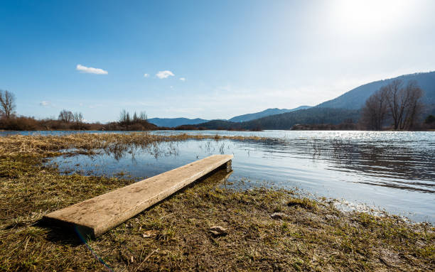 View of amazing lake Cerknica in Slovenia - Cerkniško jezero. View of amazing lake Cerknica in Slovenia - Cerkniško jezero. Beautiful intermittent or  disappearing  lake with small boat pier in Slovenia karst, natural European landmark in Cerknica, Slovenia cerknica lake stock pictures, royalty-free photos & images