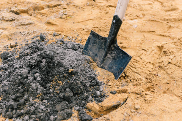istock Black shovel in the sand. A tool for scooping up sand in construction work. Sand for construction and planting works 1320133190
