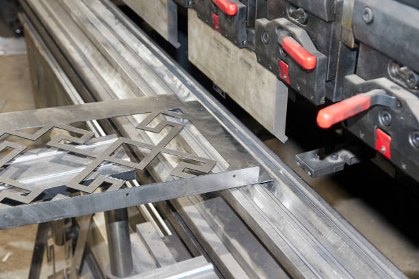 istock worker holding a metal part on sheet bending machine 1320133383