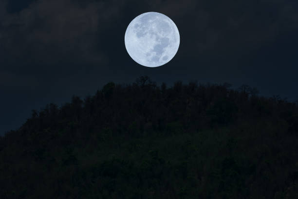 istock Full moon on the sky over mountain silhouette. 1320134331