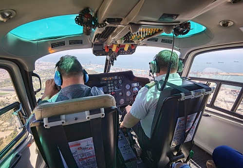 May 8, 2021 - Barcelona, Spain: Helicopter pilot and co-pilot of Cathelicopters flying over Barcelona in a Sunny day