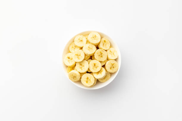 istock Many banana slices in white bowl. Top view 1320135764