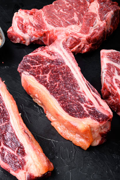 istock Club steak raw marbled beef meat, on black stone background 1320136193