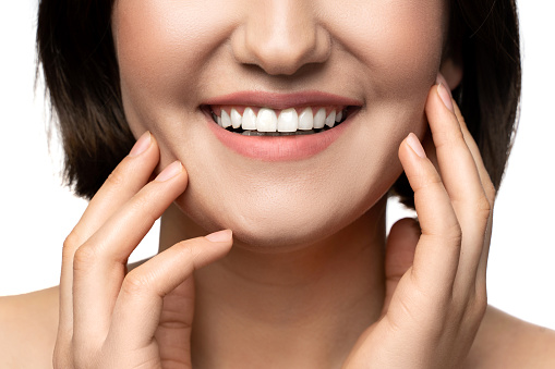 Closeup of beautiful female smile with a white teeth