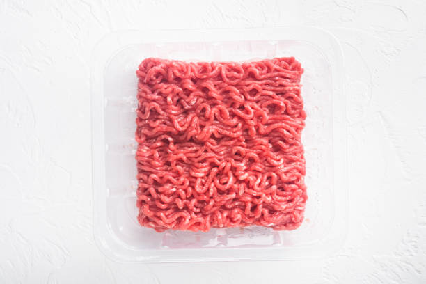 istock Raw Minced Meat in a transparent Plastic Container, on white stone  background, top view flat lay, with copy space for text 1320137655