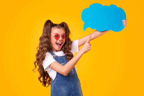 istock Delighted girl with speech bubble in bright studio 1320137741