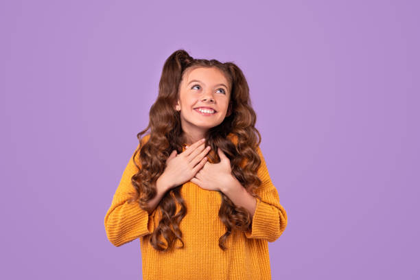 Dreamy girl with hands on chest