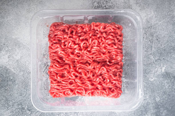 istock Opened plastic tray with fresh raw minced beef  meat, on gray stone background, top view flat lay 1320138455