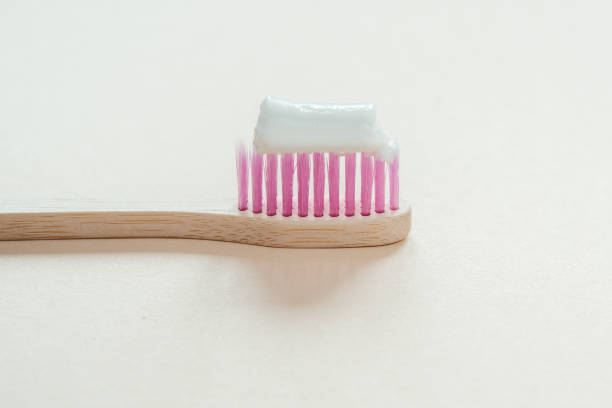 istock Pink bamboo toothbrush with tooth paste on it close-up, dental care with zero waste concept, sustainable lifestyle 1320140075