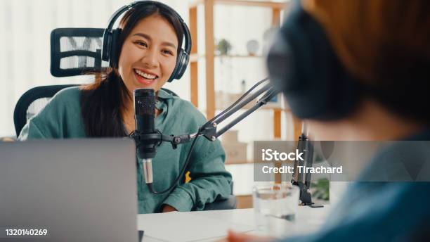 Asia Girl Radio Host Record Podcast Use Microphone Wear Headphone Interview Celebrity Guest Content Conversation Talk And Listen In Her Room Stock Photo - Download Image Now