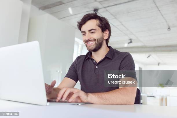 Cheerful Man Working In The Office Stock Photo - Download Image Now - Polo Shirt, Men, Office