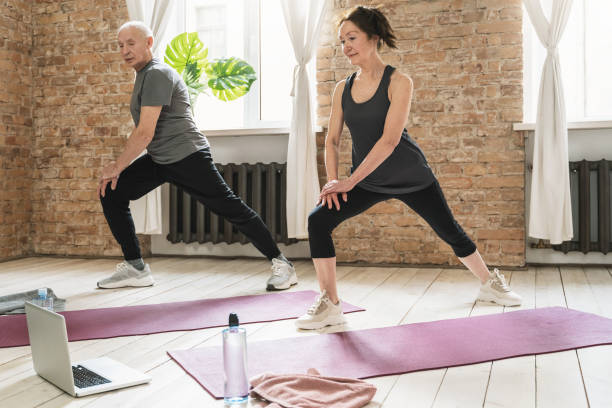 istock Active elderly people during fitness workout with an online class at home. 1320141274