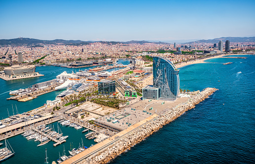 Front of Barcelona from the air with the port vell, the business center and the hotel w on a sunny day