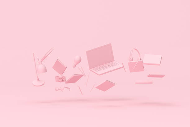 istock 3d rendering of floating laptop and office accessories on pink background. 1320142375