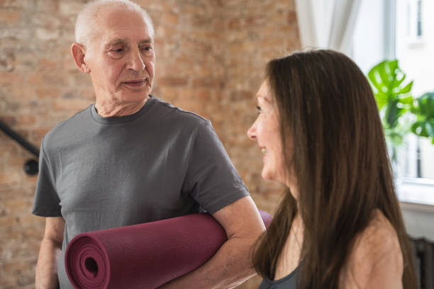 istock Two cheerful and active old people with exercising mats ready for workout 1320142451