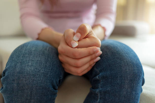 istock Cropped shot of a unrecognized young woman sitting on a sofa and feeling anxious. 1320142529