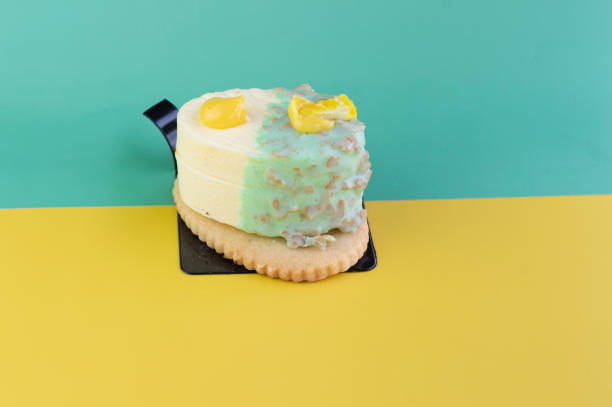 Delicious lemon and white chocolate crunchy dessert with sweet cookie on a background with bright colors.