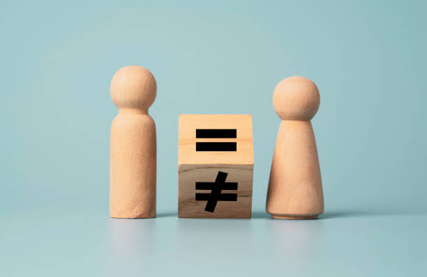 Flipping of unequal to equal sign between man and woman wooden figure. Human and business right concept. Flipping of unequal to equal sign between man and woman wooden figure. Human and business right concept. equality stock pictures, royalty-free photos & images