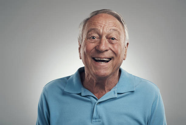 istock Shot of a man happily smiling at the camera in a studio against a grey background 1320142937